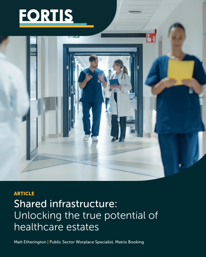 A hospital corridor scene with healthcare staff walking and talking, including a doctor and a nurse discussing notes in the centre. In the foreground, another staff member in scrubs reads a yellow folder. The image includes a FORTIS banner and the article title: “Shared infrastructure: Unlocking the true potential of healthcare estates” by Matt Etherington, Public Sector Workplace Specialist at Matrix Booking.