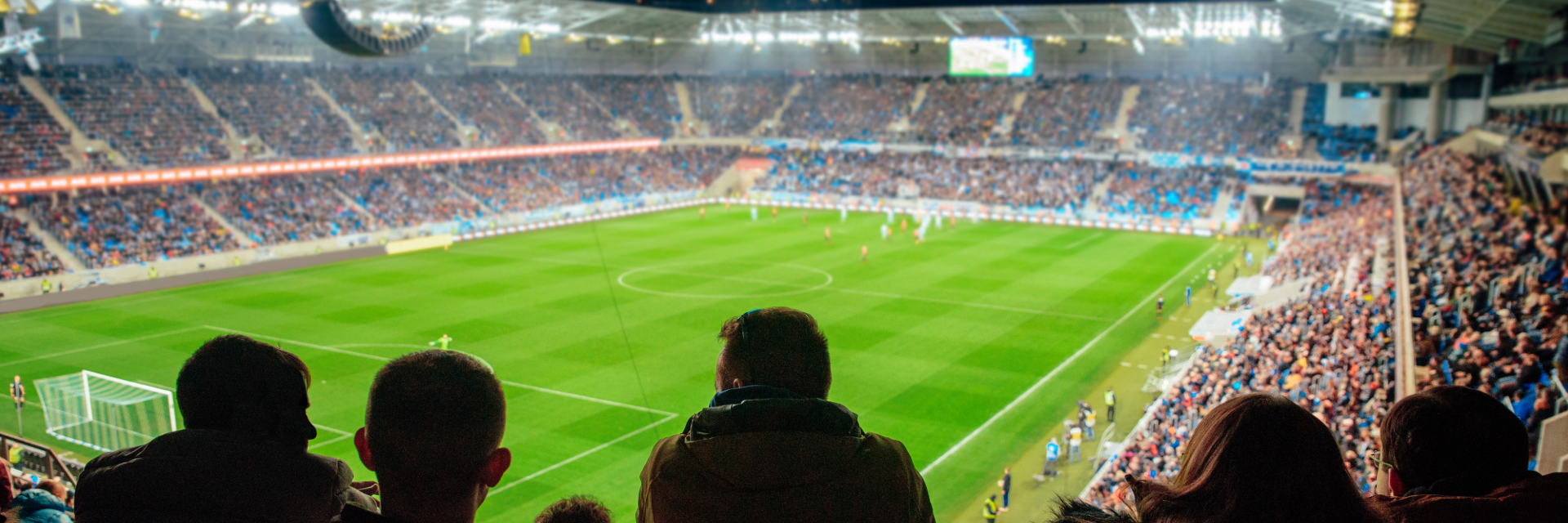 Fans watching a football game at a stadium